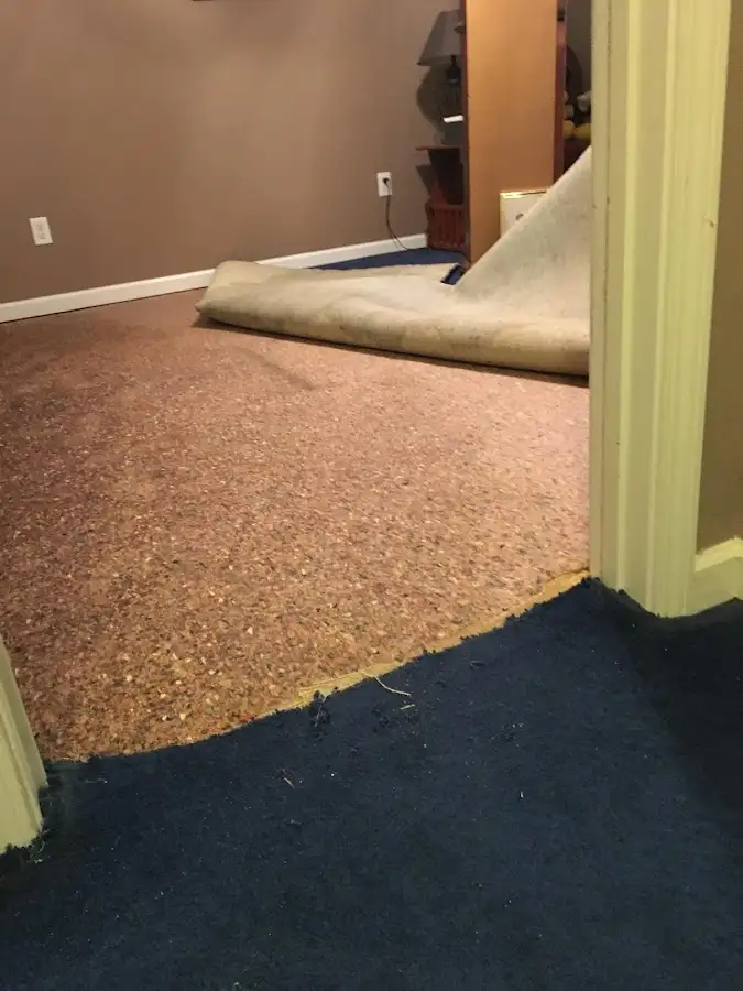 Carpet pad removal revealing water damage during Drying & Dehumidification in Eagle